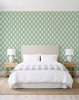 Butter Ogee Sage ogee trellis wallpaper behind a queen bed in a bright coastal bedroom