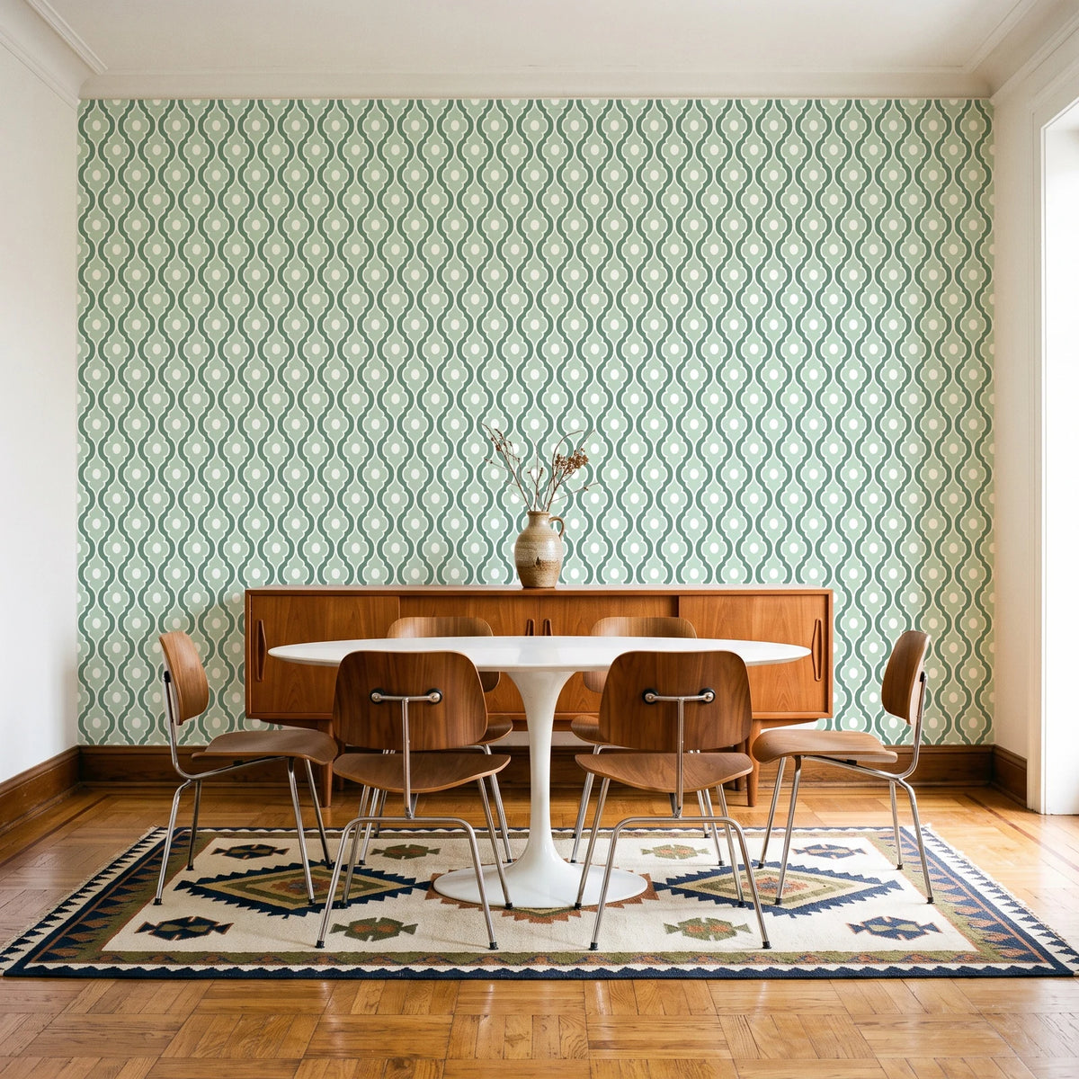 Butter Ogee Sage ogee trellis wallpaper in a mid-century dining room with a teak sideboard and tulip table