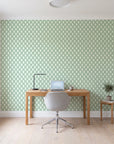 Butter Ogee Sage ogee trellis wallpaper behind a modern oak desk in a bright home office
