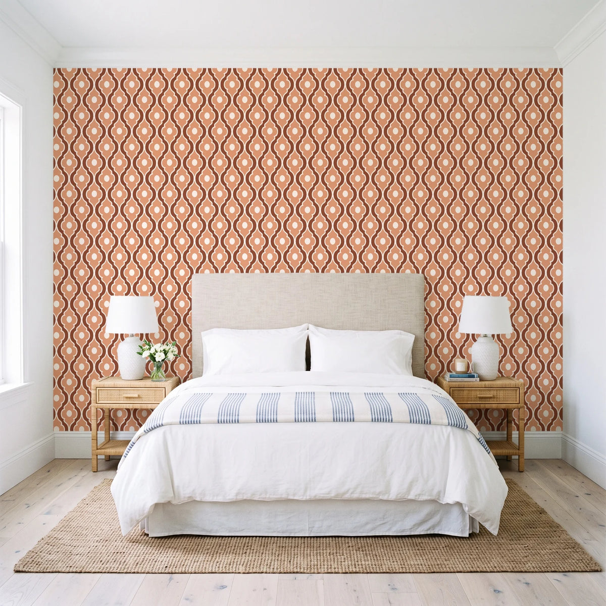 Butter Ogee Terracotta ogee trellis wallpaper behind a queen bed in a bright coastal bedroom