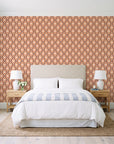 Butter Ogee Terracotta ogee trellis wallpaper behind a queen bed in a bright coastal bedroom