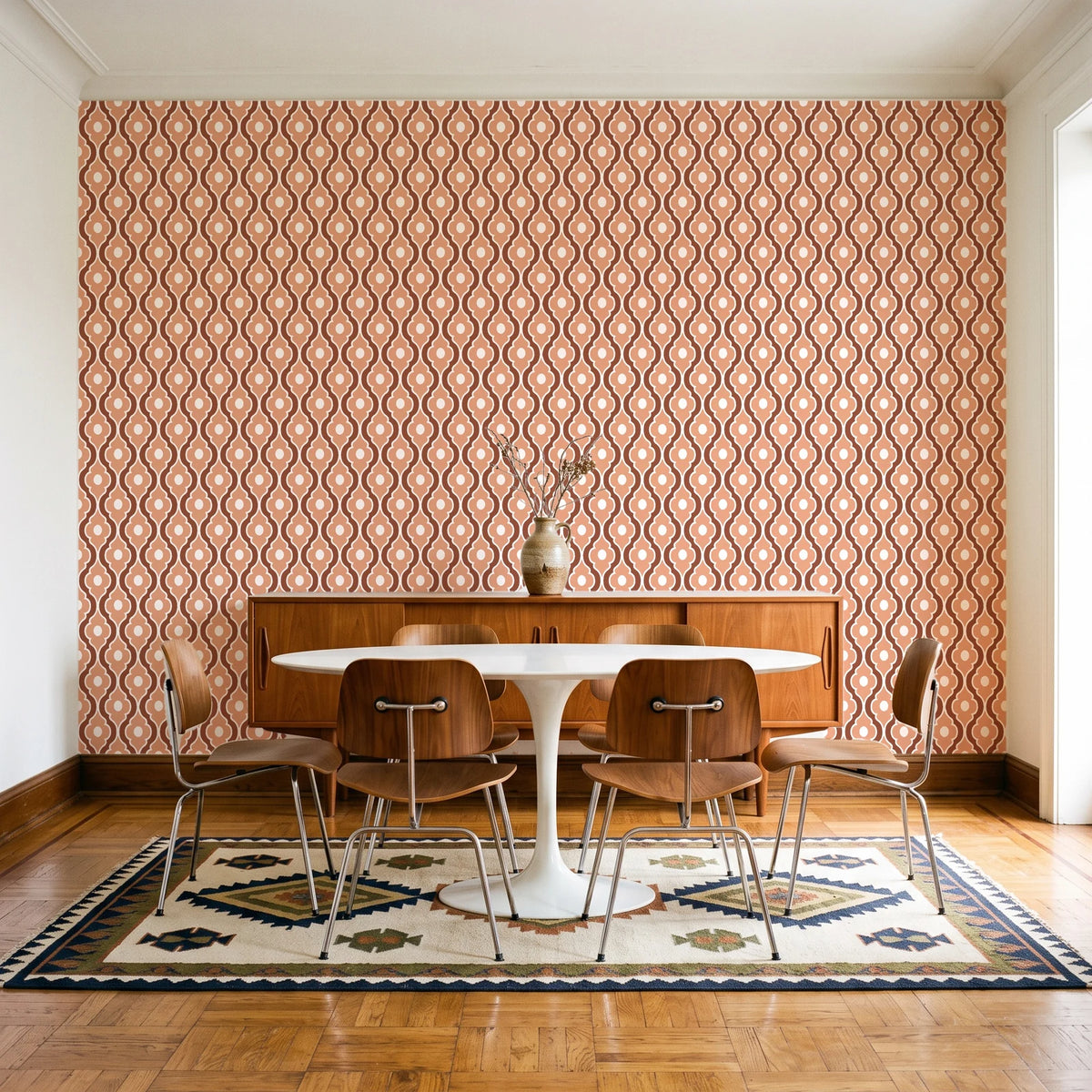 Butter Ogee Terracotta ogee trellis wallpaper in a mid-century dining room with a teak sideboard and tulip table