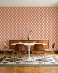 Butter Ogee Terracotta ogee trellis wallpaper in a mid-century dining room with a teak sideboard and tulip table