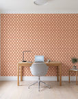 Butter Ogee Terracotta ogee trellis wallpaper behind a modern oak desk in a bright home office