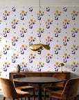 Buttercup Meadow Plum floral sprig wallpaper behind a walnut credenza and round table in an elegant dining room