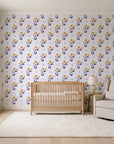 Buttercup Meadow Plum floral sprig wallpaper in a calm, light-filled nursery