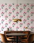 Buttercup Meadow Rose floral sprig wallpaper behind a walnut credenza and round table in an elegant dining room