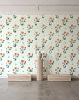 Buttercup Meadow Sage floral sprig wallpaper behind a travertine pedestal and vase in a minimal boutique