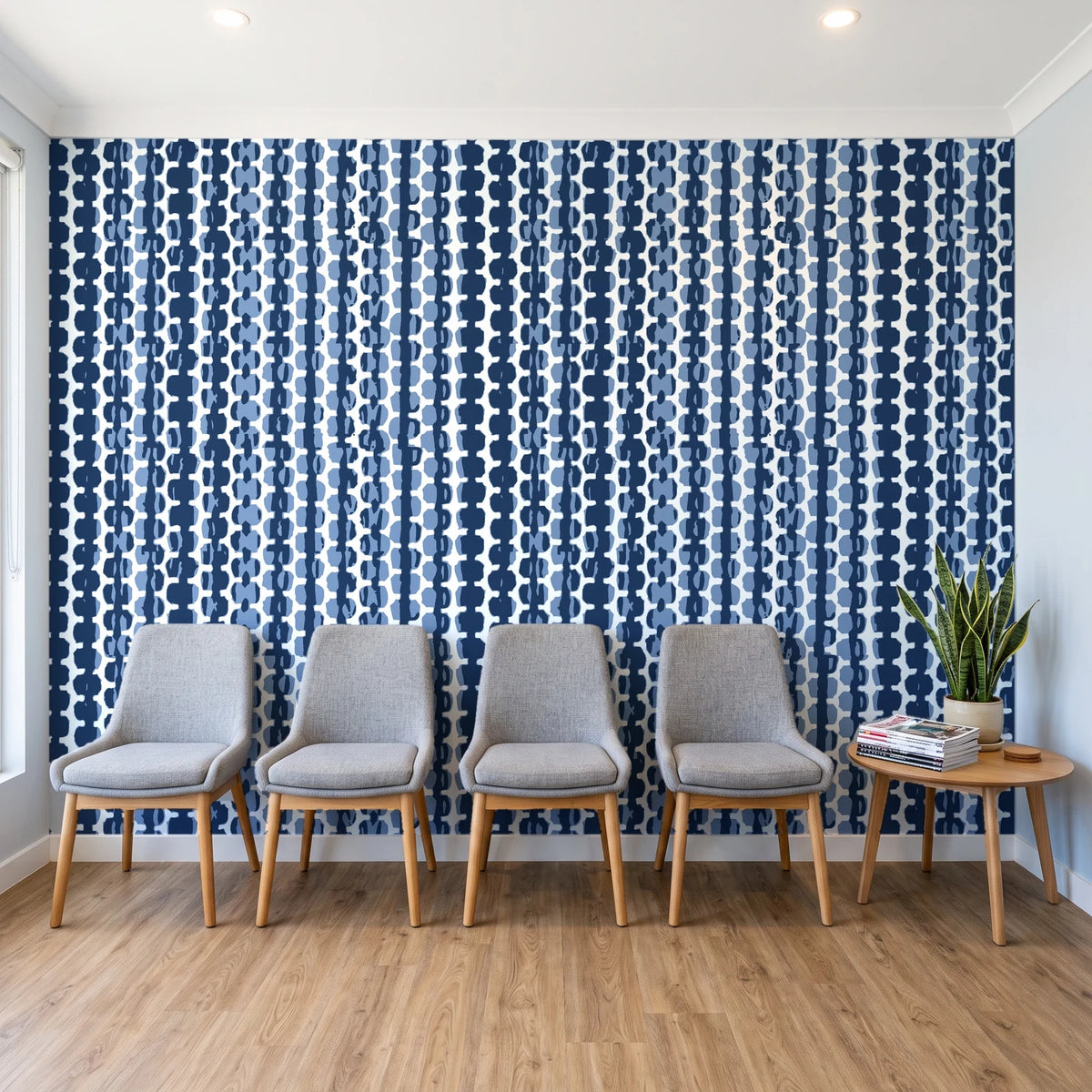 Cactus Lane Navy abstract stripe wallpaper behind a row of upholstered chairs in a bright clinic waiting room