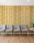 Cactus Lane Ochre abstract stripe wallpaper behind a row of upholstered chairs in a bright clinic waiting room