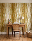 Cactus Lane Ochre abstract stripe wallpaper behind a vintage writing desk in a cozy craft-room home office