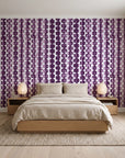 Cactus Lane Plum abstract stripe wallpaper behind a low platform bed in a serene Japandi bedroom
