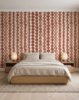 Cactus Lane Terracotta abstract stripe wallpaper behind a low platform bed in a serene Japandi bedroom
