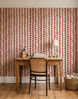 Cactus Lane Terracotta abstract stripe wallpaper behind a vintage writing desk in a cozy craft-room home office