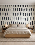 Canvas Dash Charcoal minimalist dashes wallpaper behind a low platform bed in a serene Japandi bedroom