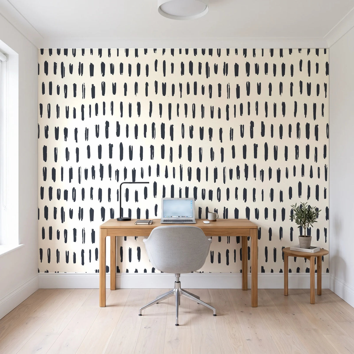 Canvas Dash Charcoal minimalist dashes wallpaper behind a modern oak desk in a bright home office