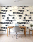 Canvas Dash Charcoal minimalist dashes wallpaper behind a modern oak desk in a bright home office