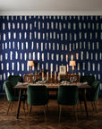Canvas Dash Midnight minimalist dashes wallpaper in a dark moody dining room with a candlelit table