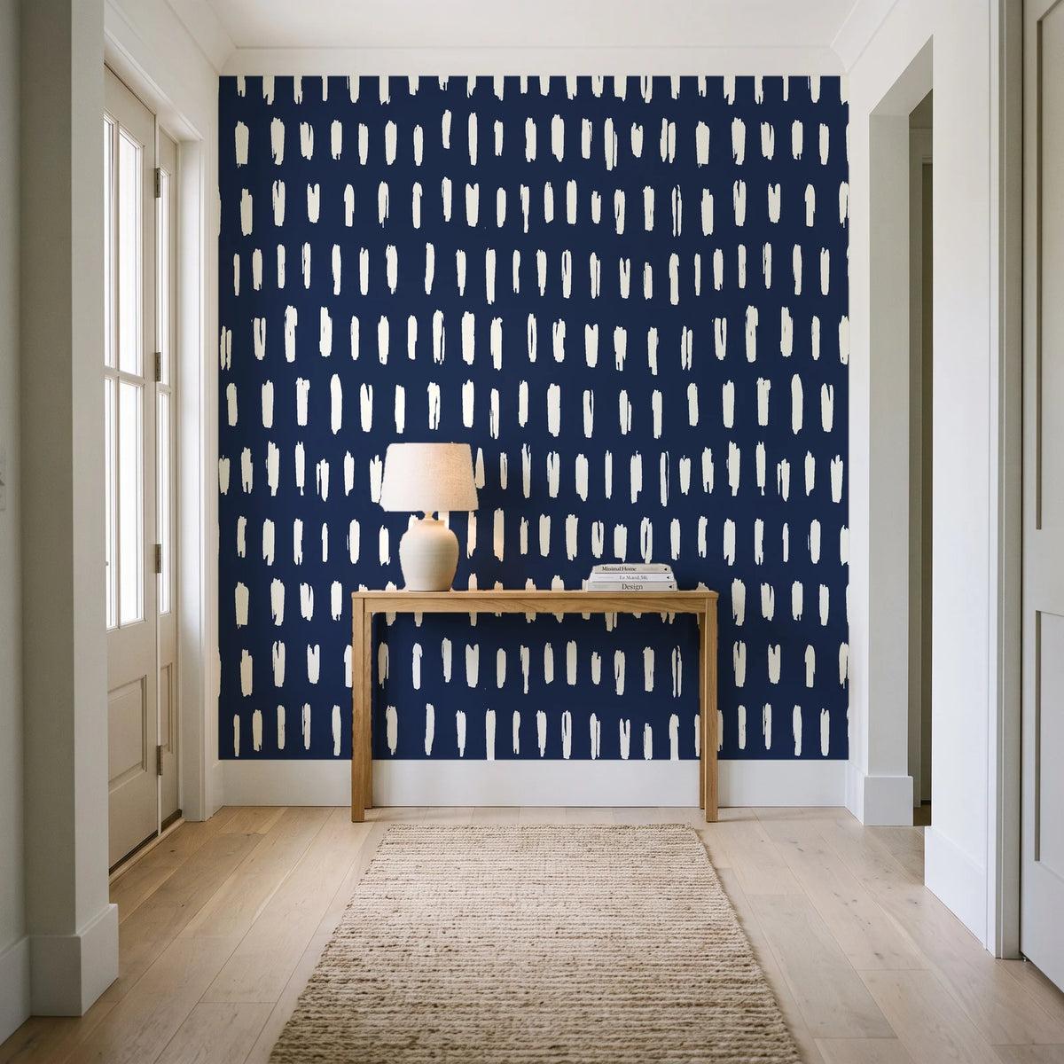 Canvas Dash Midnight minimalist dashes wallpaper behind a console table in a light entry hallway