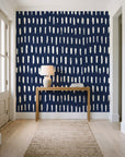 Canvas Dash Midnight minimalist dashes wallpaper behind a console table in a light entry hallway