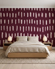 Canvas Dash Oxblood minimalist dashes wallpaper behind a low platform bed in a serene Japandi bedroom