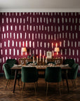 Canvas Dash Oxblood minimalist dashes wallpaper in a dark moody dining room with a candlelit table