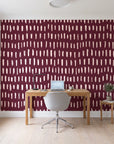 Canvas Dash Oxblood minimalist dashes wallpaper behind a modern oak desk in a bright home office