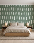 Canvas Dash Sage minimalist dashes wallpaper behind a low platform bed in a serene Japandi bedroom
