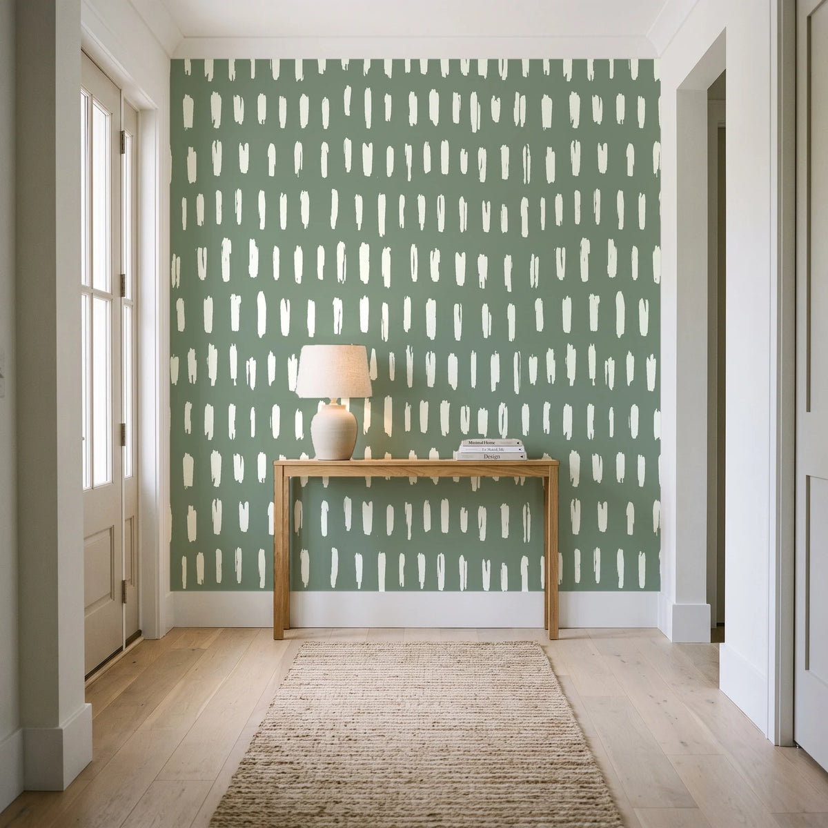 Canvas Dash Sage minimalist dashes wallpaper behind a console table in a light entry hallway