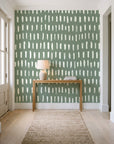 Canvas Dash Sage minimalist dashes wallpaper behind a console table in a light entry hallway