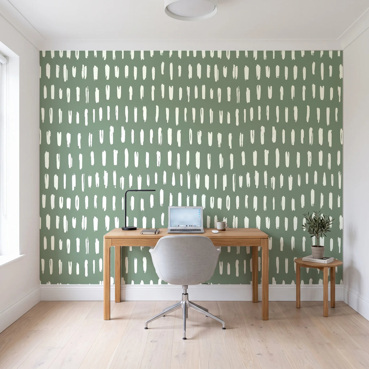 Canvas Dash Sage minimalist dashes wallpaper behind a modern oak desk in a bright home office