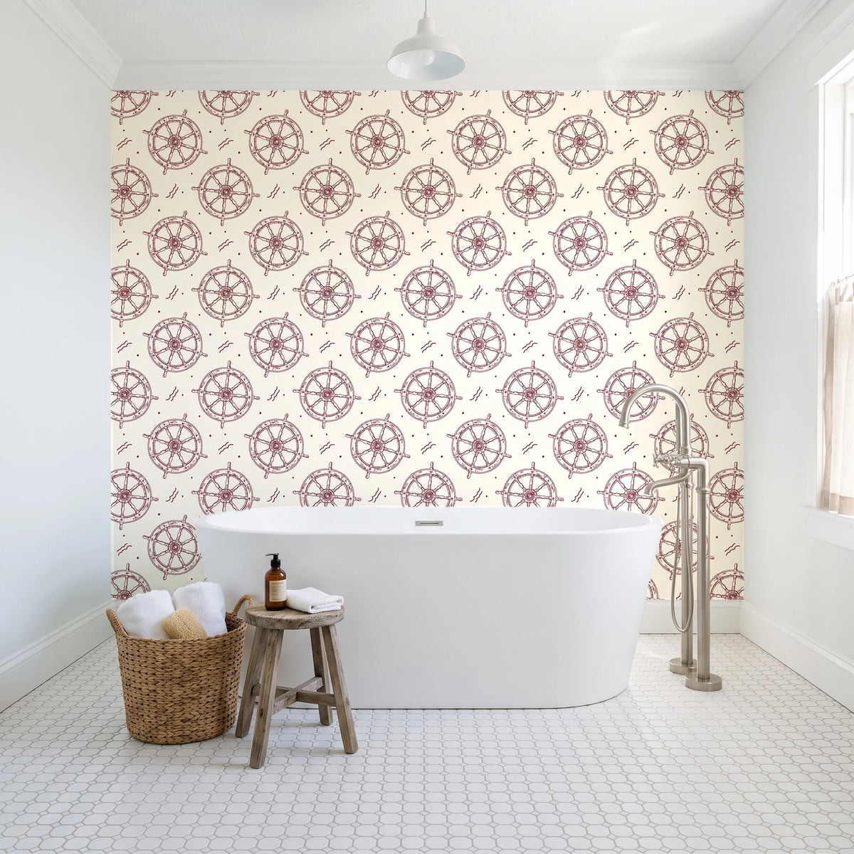 Captain's Wheel Burgundy nautical ship wheel wallpaper behind a freestanding tub in a bright coastal bathroom