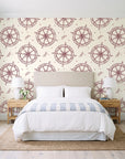 Captain's Wheel Burgundy nautical ship wheel wallpaper behind a queen bed in a bright coastal bedroom