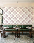 Captain's Wheel Burgundy nautical ship wheel wallpaper above a green leather banquette in a sunlit neighborhood cafe