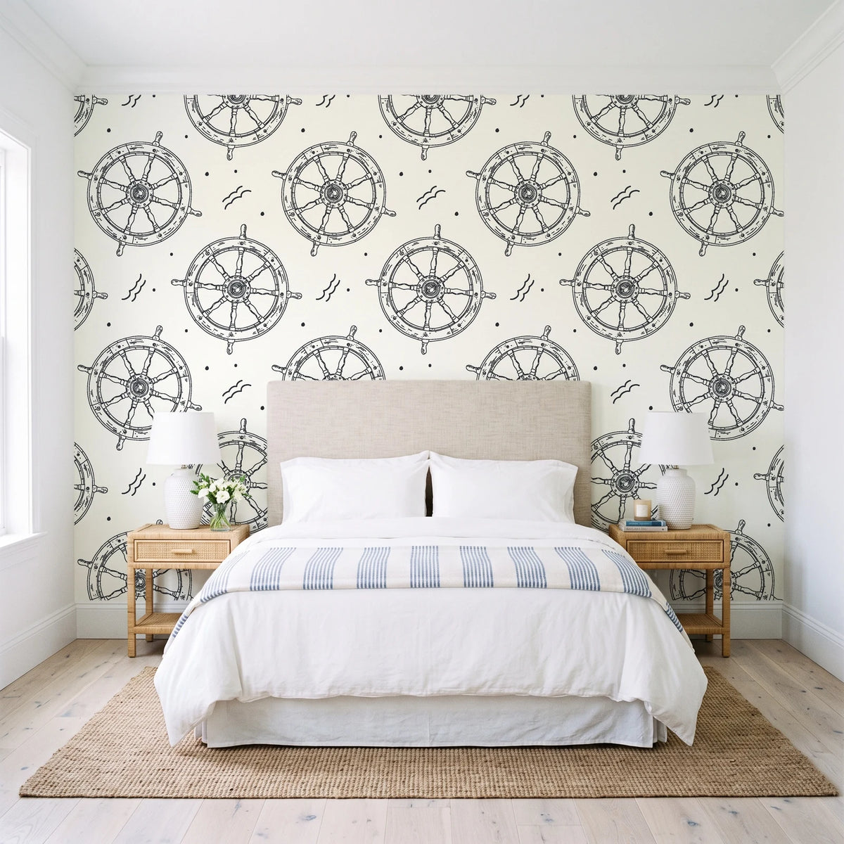 Captain's Wheel Charcoal nautical ship wheel wallpaper behind a queen bed in a bright coastal bedroom