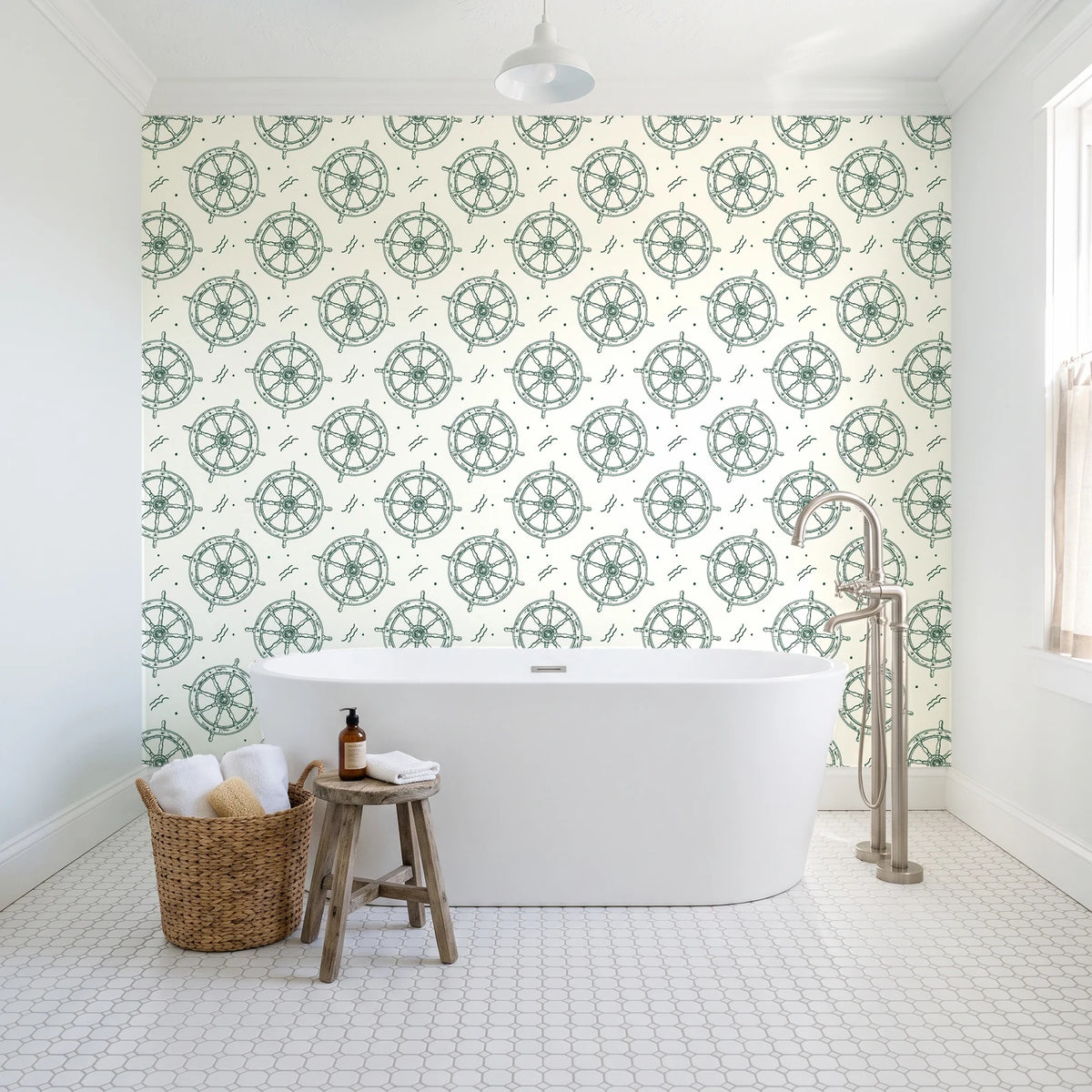 Captain's Wheel Evergreen nautical ship wheel wallpaper behind a freestanding tub in a bright coastal bathroom