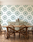 Captain's Wheel Evergreen nautical ship wheel wallpaper in a farmhouse dining room with a sage sideboard and rustic trestle table