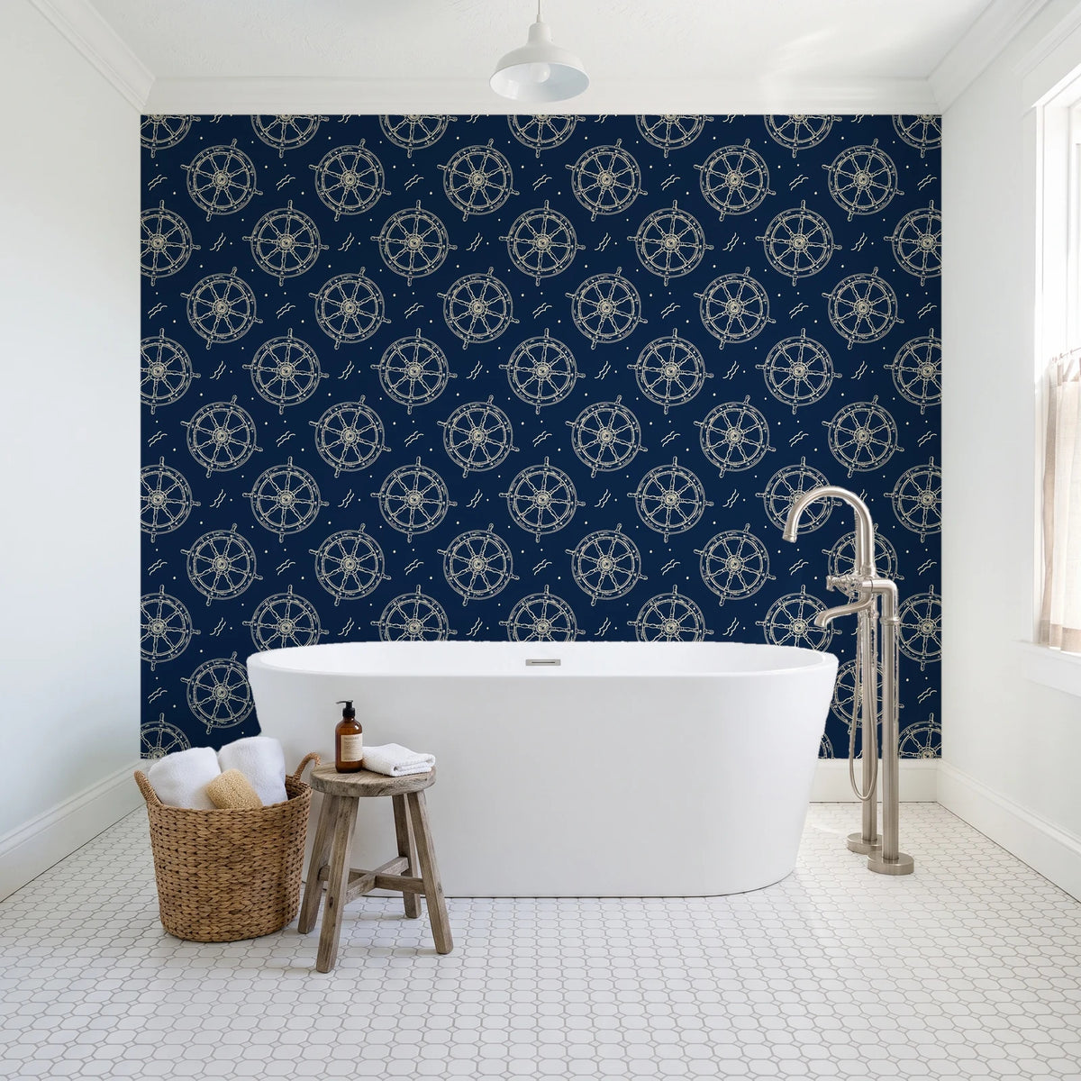 Captain's Wheel Midnight nautical ship wheel wallpaper behind a freestanding tub in a bright coastal bathroom
