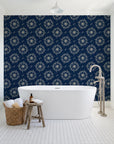 Captain's Wheel Midnight nautical ship wheel wallpaper behind a freestanding tub in a bright coastal bathroom