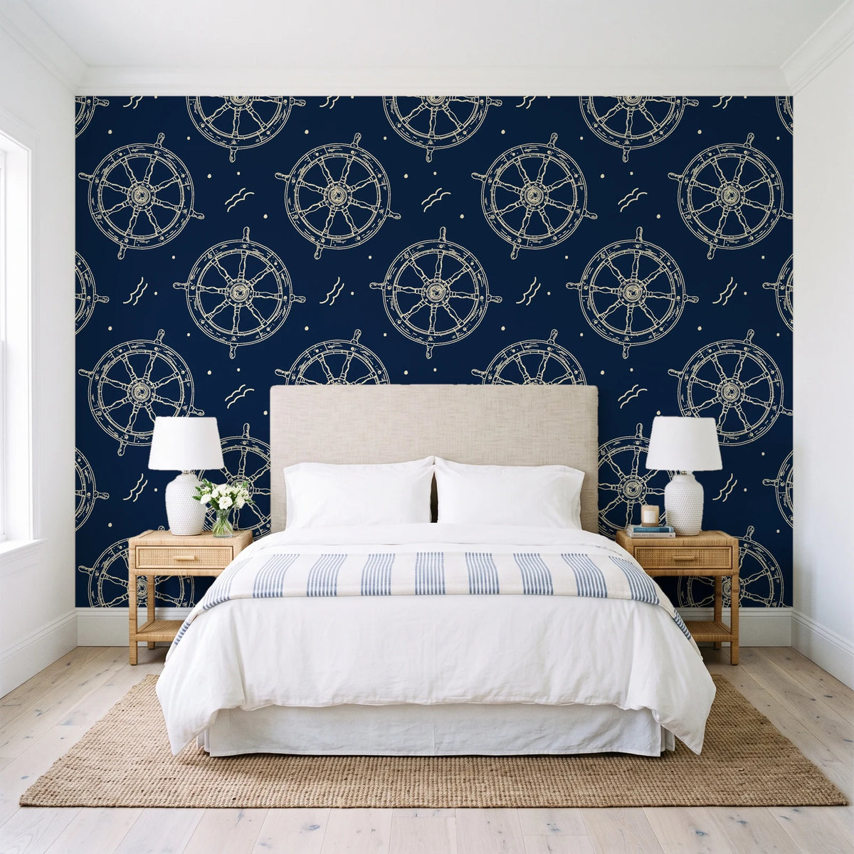 Captain's Wheel Midnight nautical ship wheel wallpaper behind a queen bed in a bright coastal bedroom