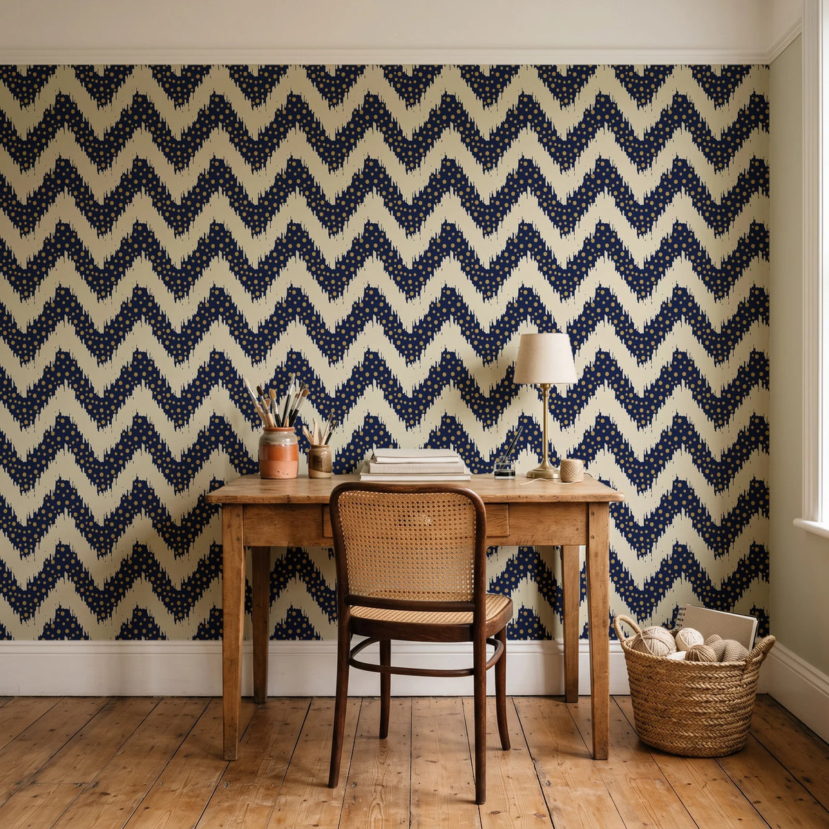 Caramel Drip Midnight chevron wallpaper behind a vintage writing desk in a cozy craft-room home office
