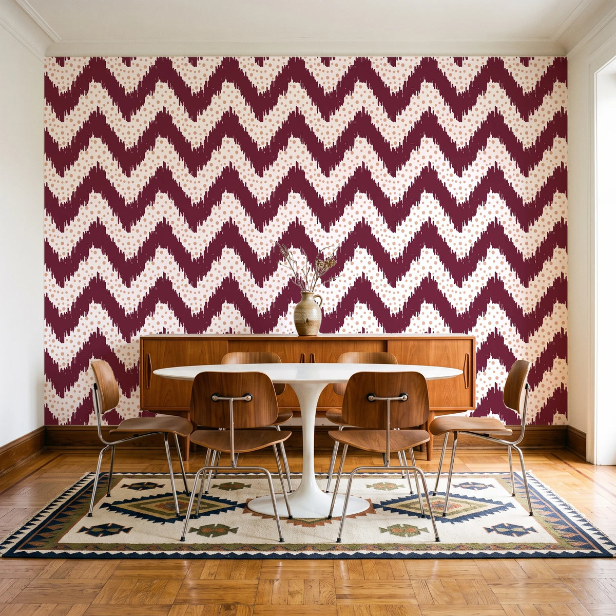 Caramel Drip Oxblood chevron wallpaper in a mid-century dining room with a teak sideboard and tulip table