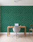 Caramel Haze Emerald brushstroke dot wallpaper behind a modern oak desk in a bright home office
