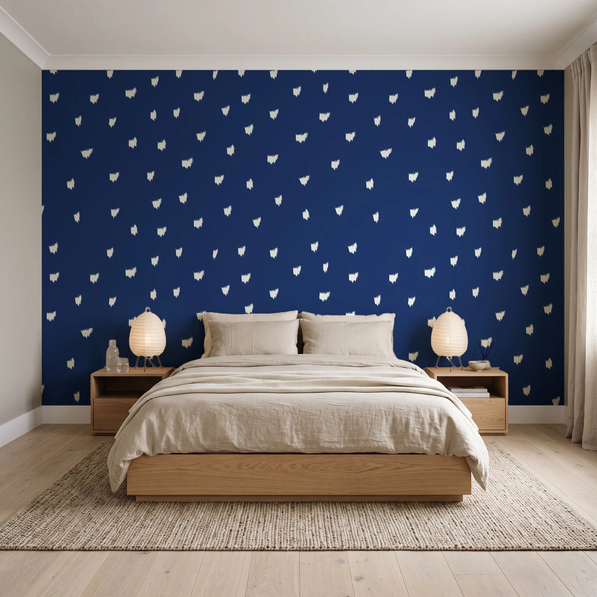 Caramel Haze Navy brushstroke dot wallpaper behind a low platform bed in a serene Japandi bedroom