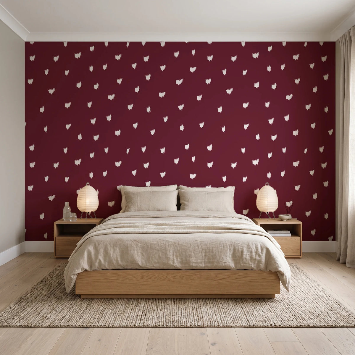 Caramel Haze Oxblood brushstroke dot wallpaper behind a low platform bed in a serene Japandi bedroom