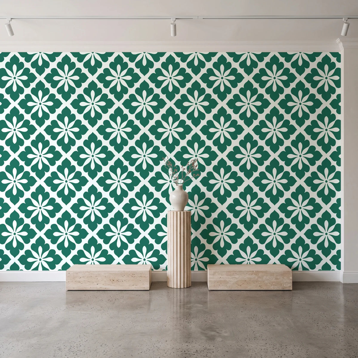 Carbon Bloom Emerald tile floral wallpaper behind a travertine pedestal and vase in a minimal boutique