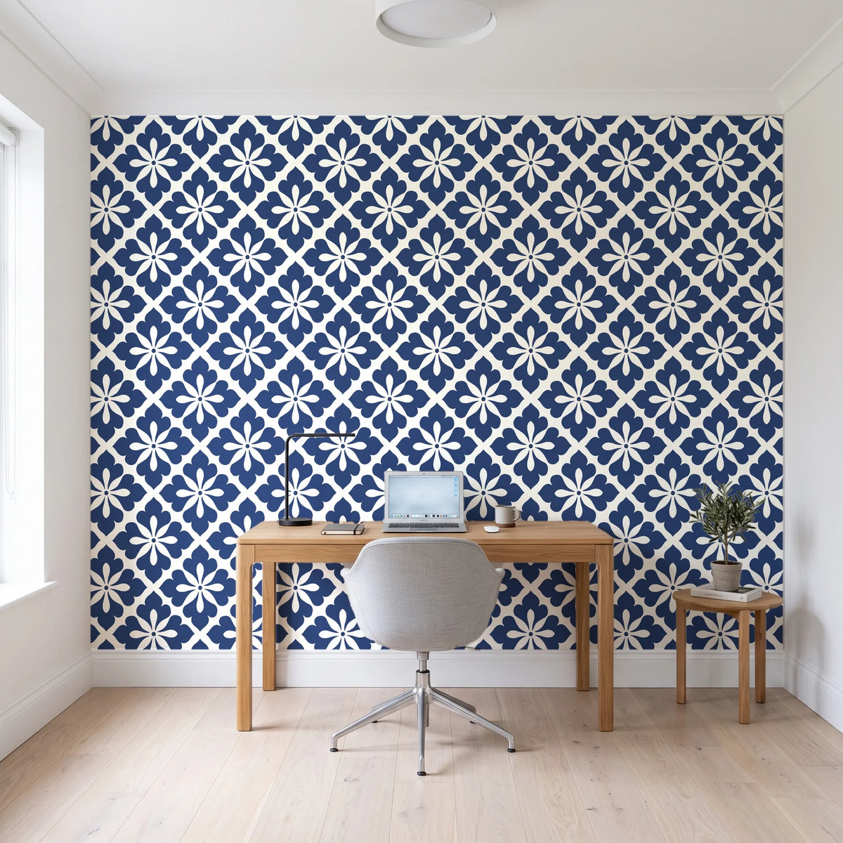 Carbon Bloom Navy tile floral wallpaper behind a modern oak desk in a bright home office