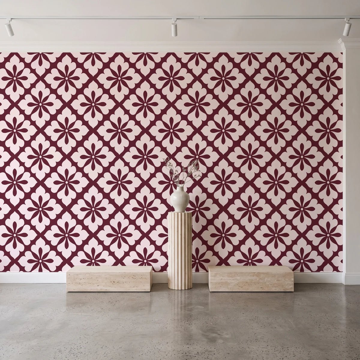 Carbon Bloom Oxblood tile floral wallpaper behind a travertine pedestal and vase in a minimal boutique