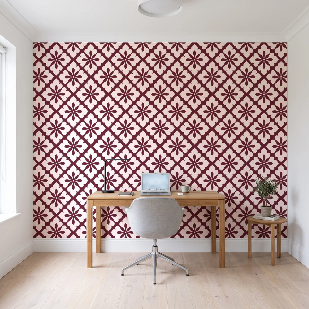 Carbon Bloom Oxblood tile floral wallpaper behind a modern oak desk in a bright home office