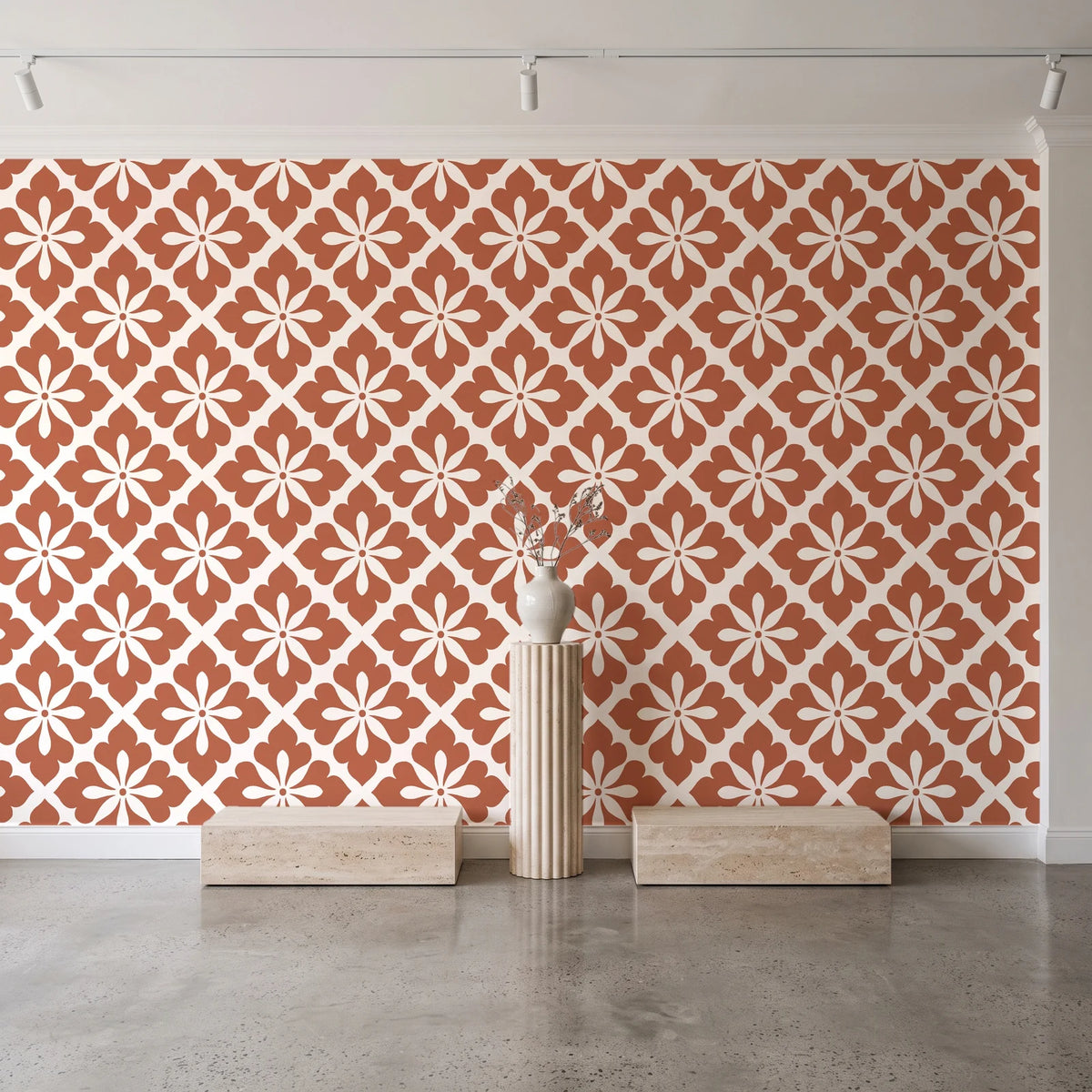 Carbon Bloom Terracotta tile floral wallpaper behind a travertine pedestal and vase in a minimal boutique